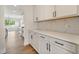 Kitchen featuring white cabinets, black hardware, a marble backsplash, and quartz countertops at 1301 Cricket St, Elon, NC 27244