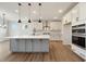 Kitchen island with white countertop and gray cabinets, stainless steel appliances at 1301 Cricket St, Elon, NC 27244