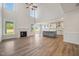 Open concept living area with kitchen, large windows, fireplace and hardwood floors at 1301 Cricket St, Elon, NC 27244