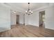 Open-concept living area with hardwood floors, decorative molding, and bright, neutral paint at 1301 Cricket St, Elon, NC 27244