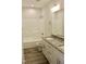 Bathroom with granite countertops, double sinks, wood-look floors, and bathtub at 59 Mossy Bridge Ct, Lillington, NC 27546