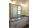 A bright bathroom is shown, featuring a double vanity with stone countertops and modern fixtures at 59 Mossy Bridge Ct, Lillington, NC 27546