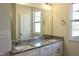 A bathroom featuring a double vanity with a stone countertop and modern fixtures at 59 Mossy Bridge Ct, Lillington, NC 27546