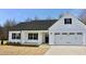 Charming white home featuring a covered porch, a two-car garage, and black shutters at 59 Mossy Bridge Ct, Lillington, NC 27546