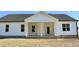 Exterior side view of the home showcasing the covered porch and white siding at 59 Mossy Bridge Ct, Lillington, NC 27546