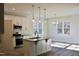 Modern eat-in kitchen features stainless steel appliances, granite countertops, and a kitchen island at 59 Mossy Bridge Ct, Lillington, NC 27546