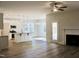 Spacious living room with wood floors, fireplace, ceiling fan, and eat-in kitchen at 59 Mossy Bridge Ct, Lillington, NC 27546