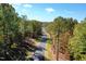 Scenic driveway winding through lush, mature trees with vibrant fall foliage at 684 Magnolia Acres Ln, Fuquay Varina, NC 27526