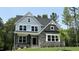 Charming two-story home with stone accents, covered porch, and a well-manicured lawn surrounded by lush trees at 684 Magnolia Acres Ln, Fuquay Varina, NC 27526