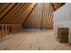 Spacious attic with exposed wooden beams and flooring, offering potential for conversion and extra storage at 70 Water Willow Ln, Zebulon, NC 27597