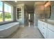 Bright bathroom with freestanding tub, double sink vanity and marble flooring at 70 Water Willow Ln, Zebulon, NC 27597