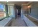 Spacious bathroom with double vanity, soaking tub, marble floors, and blue wainscoting at 70 Water Willow Ln, Zebulon, NC 27597