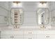 Bathroom with double vanity, white cabinets, marble countertop, and gold fixtures at 70 Water Willow Ln, Zebulon, NC 27597