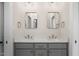 Contemporary bathroom boasts double vanity with neutral cabinets and decorative mirrors at 70 Water Willow Ln, Zebulon, NC 27597
