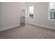 Neutral bedroom features two windows and a closet at 70 Water Willow Ln, Zebulon, NC 27597