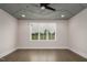 Bright bedroom featuring tray ceiling, hardwood floors and a large window with a view at 70 Water Willow Ln, Zebulon, NC 27597