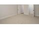 Bright bedroom with carpet, a neutral color scheme, and doorways leading to other rooms at 70 Water Willow Ln, Zebulon, NC 27597