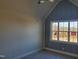 Bedroom with modern finishes, wainscoting accent wall, and a large window view at 70 Water Willow Ln, Zebulon, NC 27597