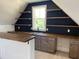 Finished bonus room features custom cabinets, dark accent wall, and open shelving at 70 Water Willow Ln, Zebulon, NC 27597
