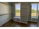 A closet featuring natural light, custom shelving, hanging rods, and hardwood floors at 70 Water Willow Ln, Zebulon, NC 27597