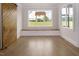 Bright dining area featuring large windows, a built-in bench, and a rustic sliding barn door at 70 Water Willow Ln, Zebulon, NC 27597