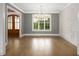Bright dining room with a stylish chandelier, decorative wall paneling, and hardwood floors at 70 Water Willow Ln, Zebulon, NC 27597