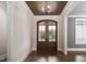 Elegant entryway featuring a wood-paneled ceiling, chandelier, and glass-paneled double doors at 70 Water Willow Ln, Zebulon, NC 27597