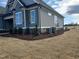 View of the exterior elevation showing the siding, windows, and landscaping details of the home at 70 Water Willow Ln, Zebulon, NC 27597