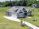 Beautiful home exterior with a three car garage and a long driveway at 70 Water Willow Ln, Zebulon, NC 27597
