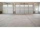 Spacious garage with multiple doors and concrete floor at 70 Water Willow Ln, Zebulon, NC 27597