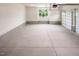 Interior of the garage with white walls, concrete floors, and a window at 70 Water Willow Ln, Zebulon, NC 27597