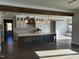 Open kitchen with an island, hardwood floors, and a view of the dining area at 70 Water Willow Ln, Zebulon, NC 27597