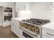 Close-up of a chef's kitchen with high-end stainless steel appliances and custom cabinetry at 70 Water Willow Ln, Zebulon, NC 27597