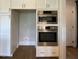 Modern kitchen appliances with stainless steel Bosch oven and microwave nestled in white cabinetry at 70 Water Willow Ln, Zebulon, NC 27597