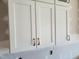 Bright kitchen featuring white cabinets with sleek hardware for a modern and clean aesthetic at 70 Water Willow Ln, Zebulon, NC 27597