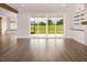 Bright living room featuring hardwood floors, a sliding glass door to the yard, and built-in shelves at 70 Water Willow Ln, Zebulon, NC 27597