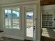 Inviting living room with large windows, a glass door, and a view to the exterior at 70 Water Willow Ln, Zebulon, NC 27597
