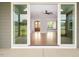 View through sliding glass doors into the open-concept living room with wood floors at 70 Water Willow Ln, Zebulon, NC 27597