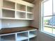 Well-lit office space with window view, dark wood countertop and custom built-in shelving at 70 Water Willow Ln, Zebulon, NC 27597