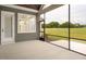 Covered porch overlooking a spacious yard and field, great for relaxing outdoors at 70 Water Willow Ln, Zebulon, NC 27597