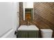 Powder room with olive green vanity and gold hardware, with paneled accent wall at 70 Water Willow Ln, Zebulon, NC 27597
