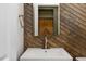 Powder room with dark wood paneled wall and brushed nickel fixtures at 70 Water Willow Ln, Zebulon, NC 27597