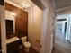 Stylish powder room featuring wood-paneled wall, modern vanity, and framed mirror at 70 Water Willow Ln, Zebulon, NC 27597