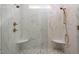 A luxurious shower has marble tile, dual shower heads, and built-in corner seats at 70 Water Willow Ln, Zebulon, NC 27597