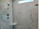 Modern shower with marble tile surround, frameless glass, and multiple shower heads at 70 Water Willow Ln, Zebulon, NC 27597