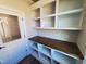 Storage room with wood counter, built in shelving and a door to the outside at 70 Water Willow Ln, Zebulon, NC 27597