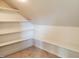 Storage room with built in shelving and neutral carpeting at 70 Water Willow Ln, Zebulon, NC 27597