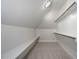 Bright walk-in closet with shelving, hanging rods, and carpeted floors for organization and storage at 70 Water Willow Ln, Zebulon, NC 27597