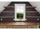 Close up of a wet bar with stainless sink, wood countertop, custom cabinets and floating shelves at 70 Water Willow Ln, Zebulon, NC 27597