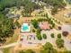 Aerial view of the neighborhood pool, clubhouse, and well-maintained parking lot at 27 Asti Ct, Clayton, NC 27527